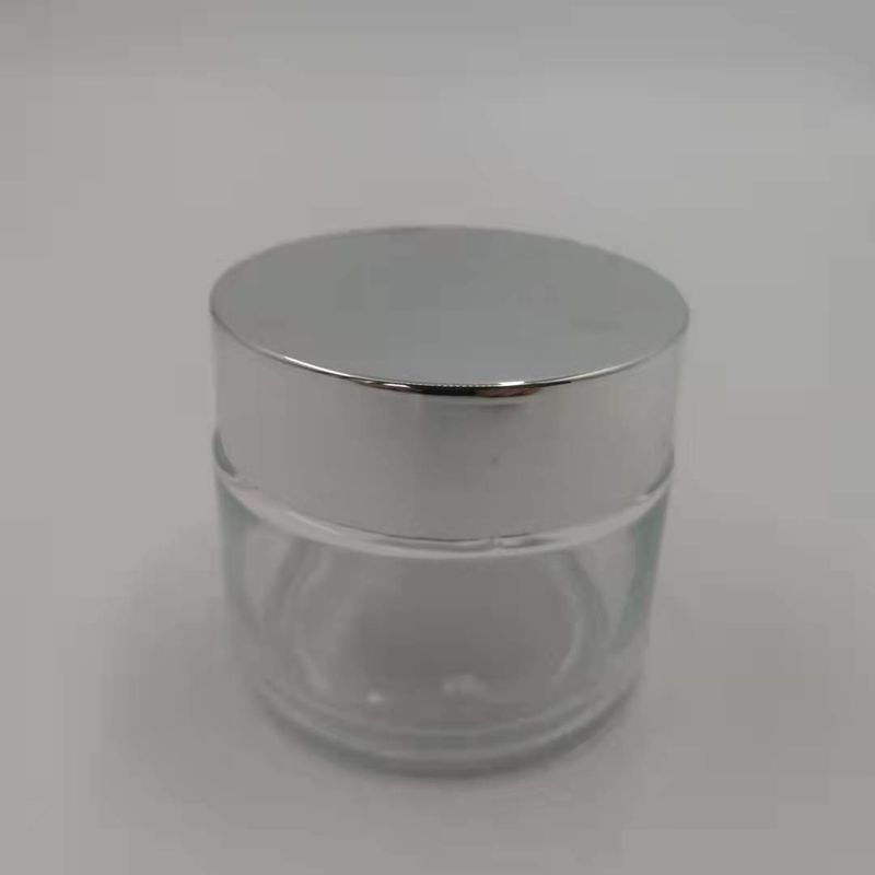 MSDS Clear 100g Glass Cream Jar With Shiny Silver Cap White Lid Mask Mud